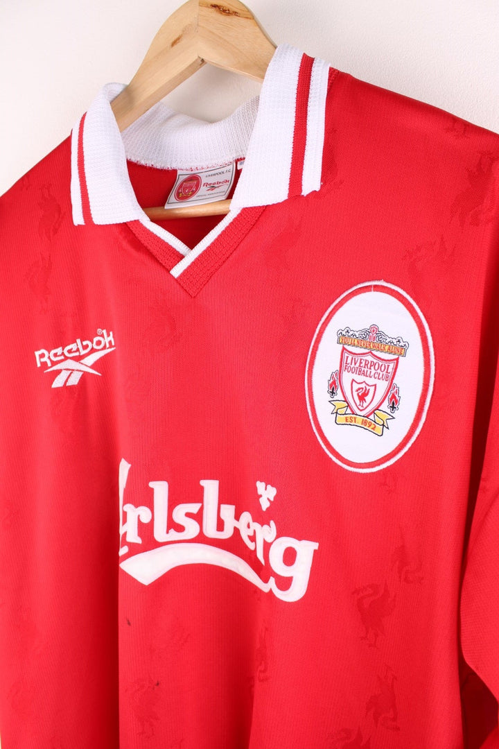 Liverpool 1996/98  Football Shirt in the  home kit colourway, features v neck collar and embroidered logos and badge on the front.