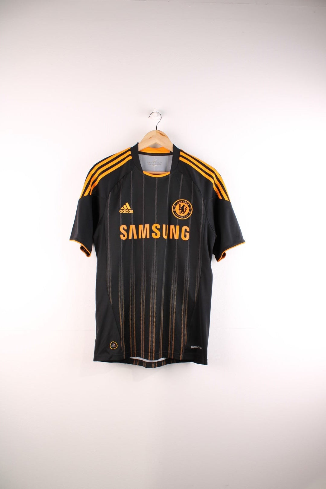 Chelsea 2010/11 Adidas Football Shirt in the black and orange away kit colourway, features embroidered logos and badge on the front and Didier Drogba number 11 printed on the back.