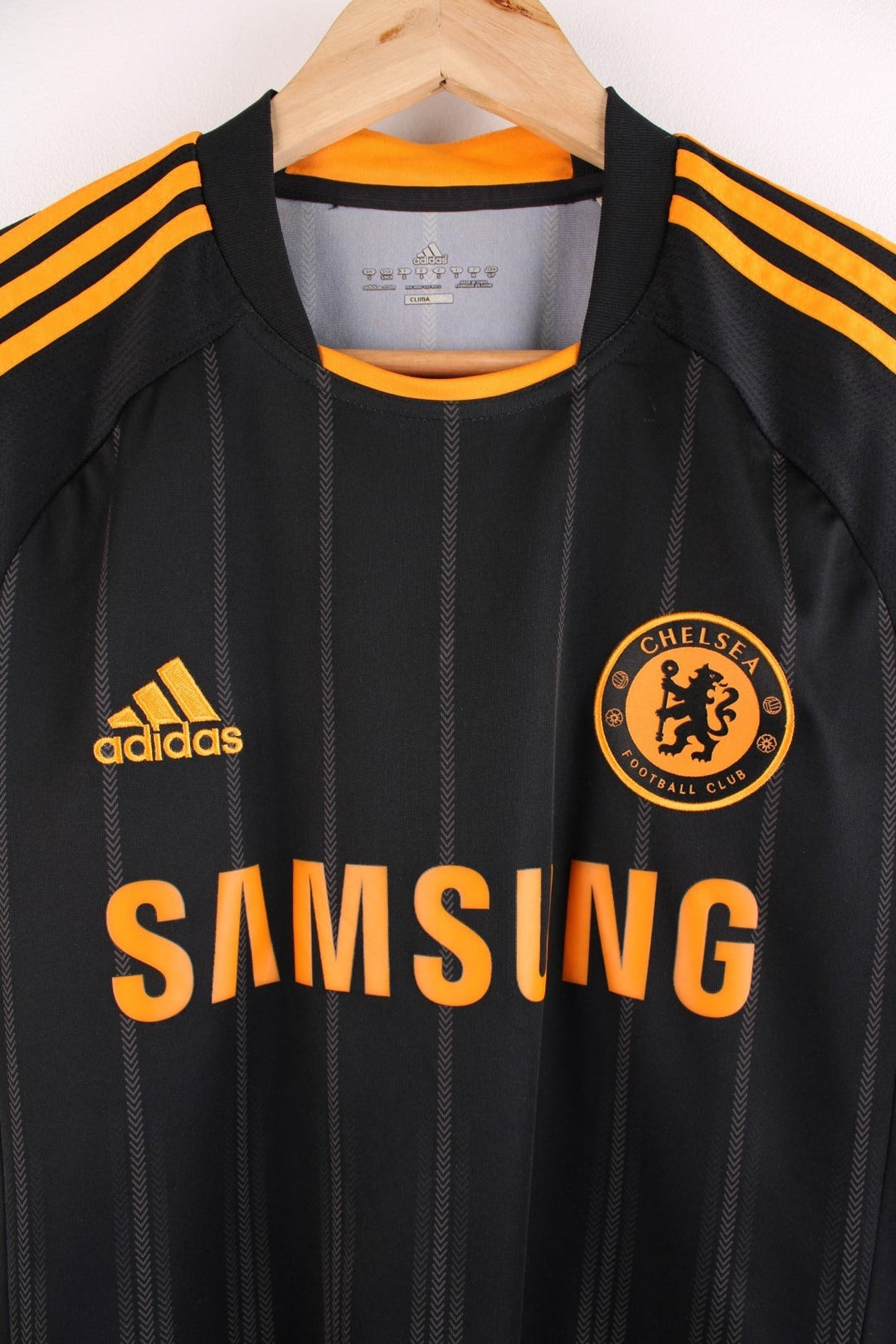 Chelsea 2010/11  Football Shirt in the  and orange away kit colourway, features embroidered logos and badge on the front and Didier Drogba number 11 printed on the back.