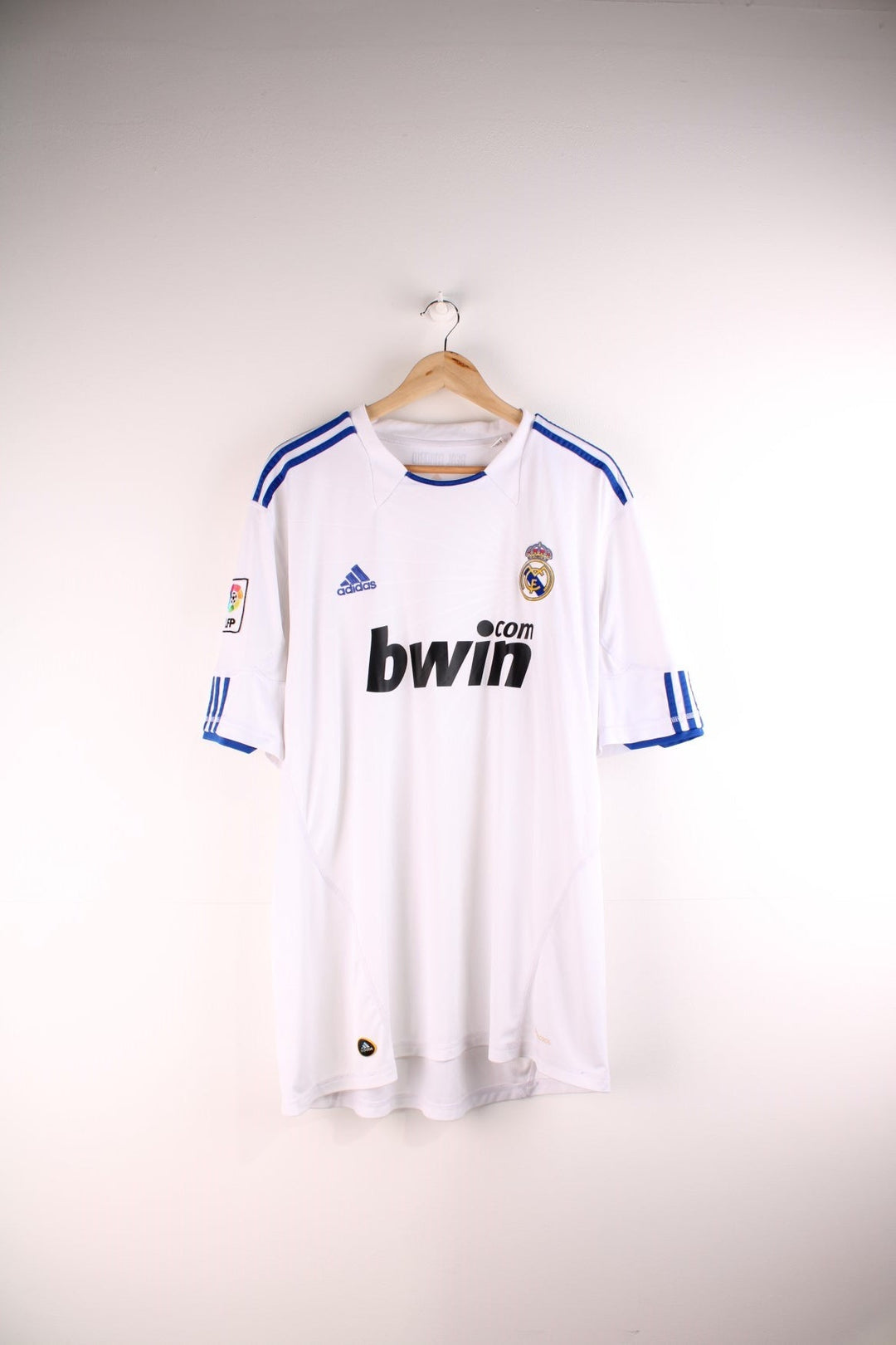 Real Madrid 2010/11 Adidas Football Shirt in the white home kit colourway, features embroidered logos and badge on the front.