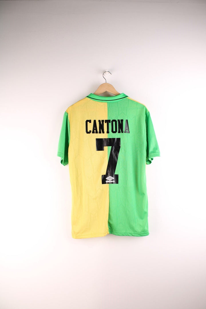 Manchester United 1992/94  Football Shirt in the  and yellow third kit colourway, features embroidered logos and badge on the front and has Eric Cantona number 7 printed on the back.