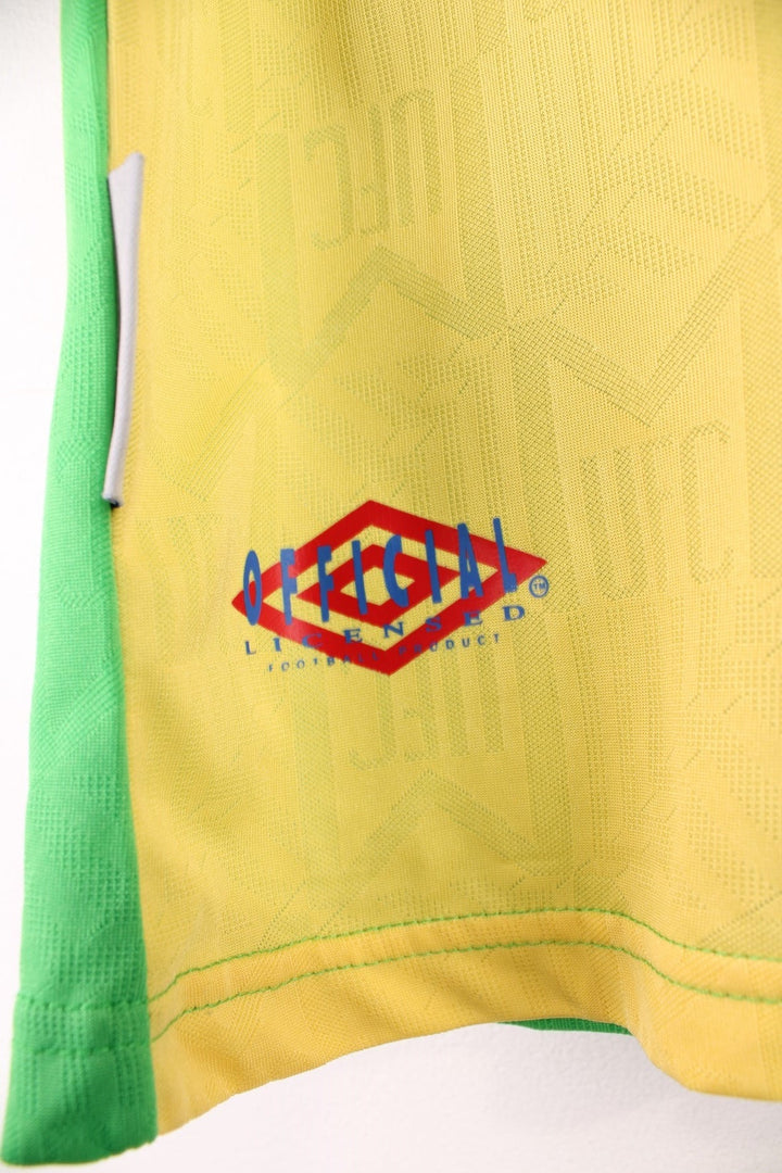 Manchester United 1992/94  Football Shirt in the  and yellow third kit colourway, features embroidered logos and badge on the front and has Eric Cantona number 7 printed on the back.