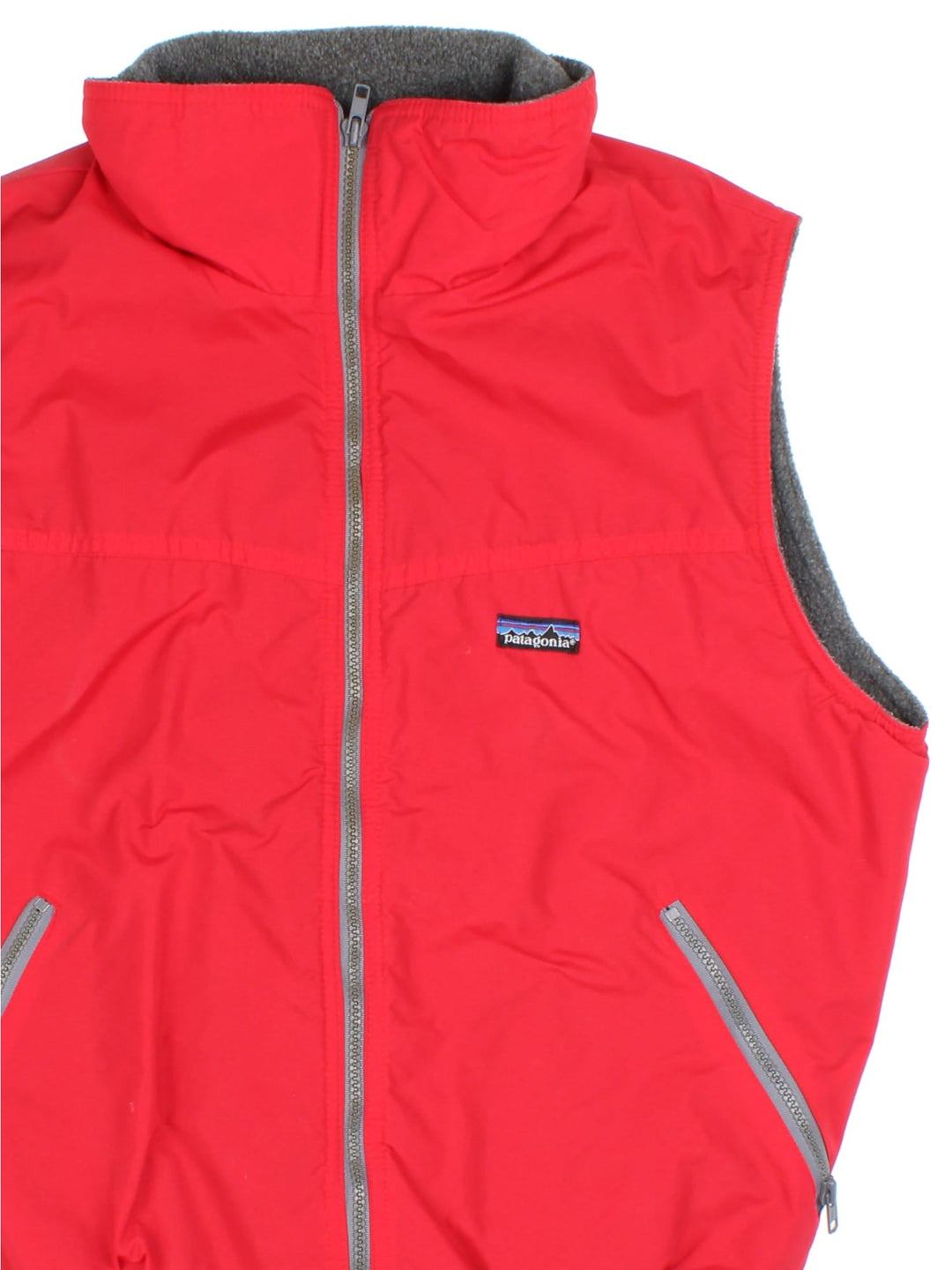 Vintage Patagonia Gilet in a red colourway. Zips up and has side pockets, insulated with a fleece lining, and has the logo embroidered on the front.