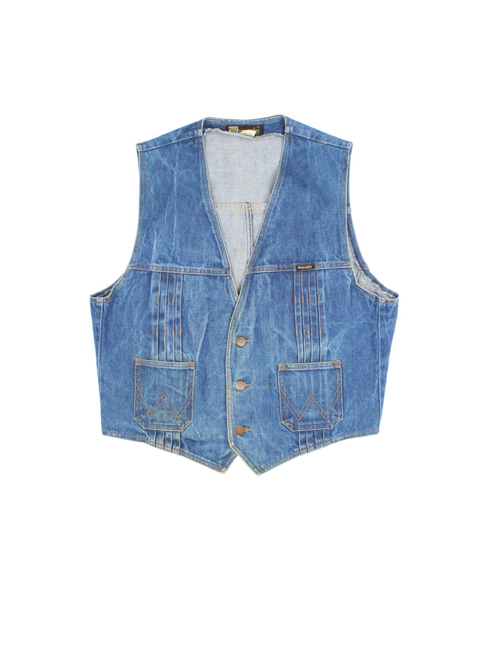 Vintage Wrangler Western Denim Vest in a blue colourway. Buttons up and has side pockets, and the logo tab embroidered on the front.