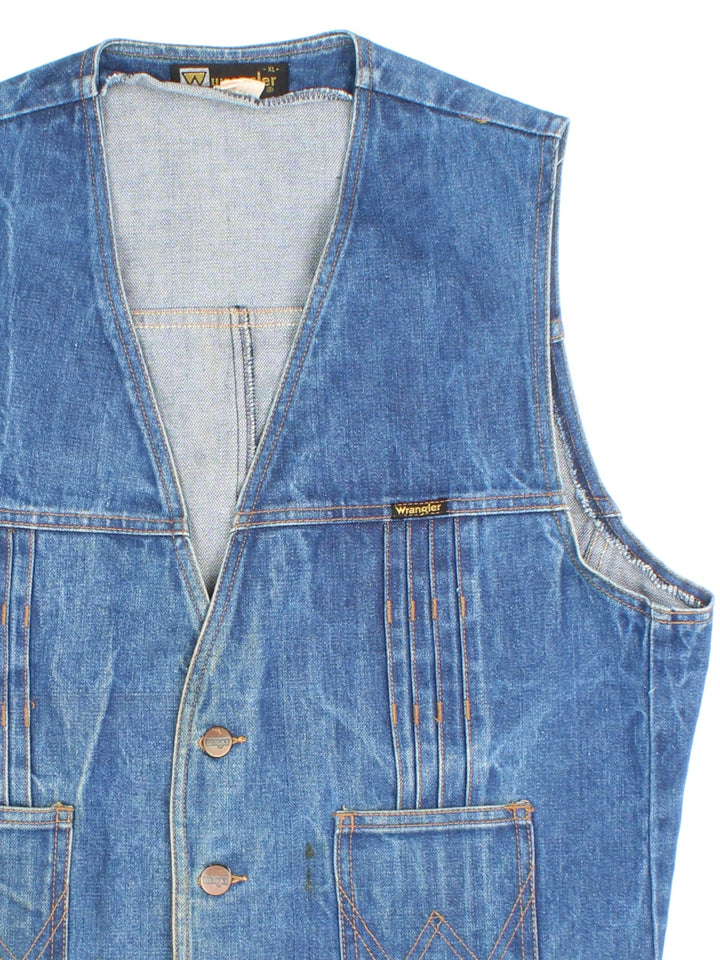 Vintage Wrangler Western Denim Vest in a blue colourway. Buttons up and has side pockets, and the logo tab embroidered on the front.