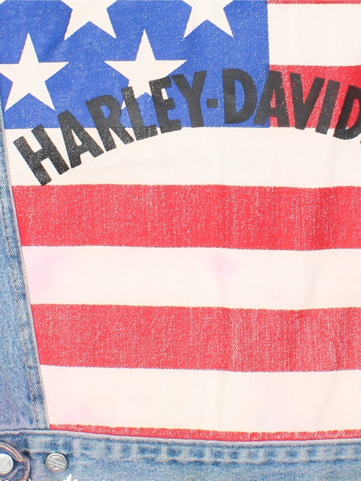 Vintage 90's Harley-Davidson USA Denim Vest in a blue colourway. Buttons up and has double chest pockets, loose stitching design round the sleeve cuffs, and has the spell out logo on the back with the USA Flag.