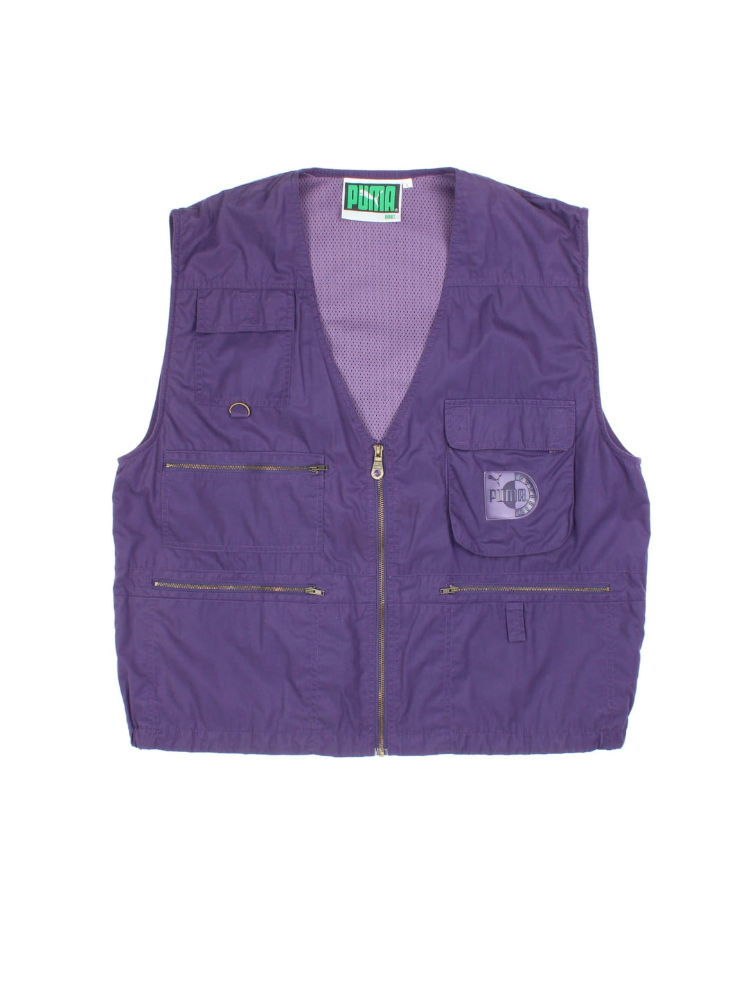 Vintage Puma Pursuit Utility Vest in a purple colourway. Zips up and has multiple pockets, mesh lining, and has the logo embroidered on the front.