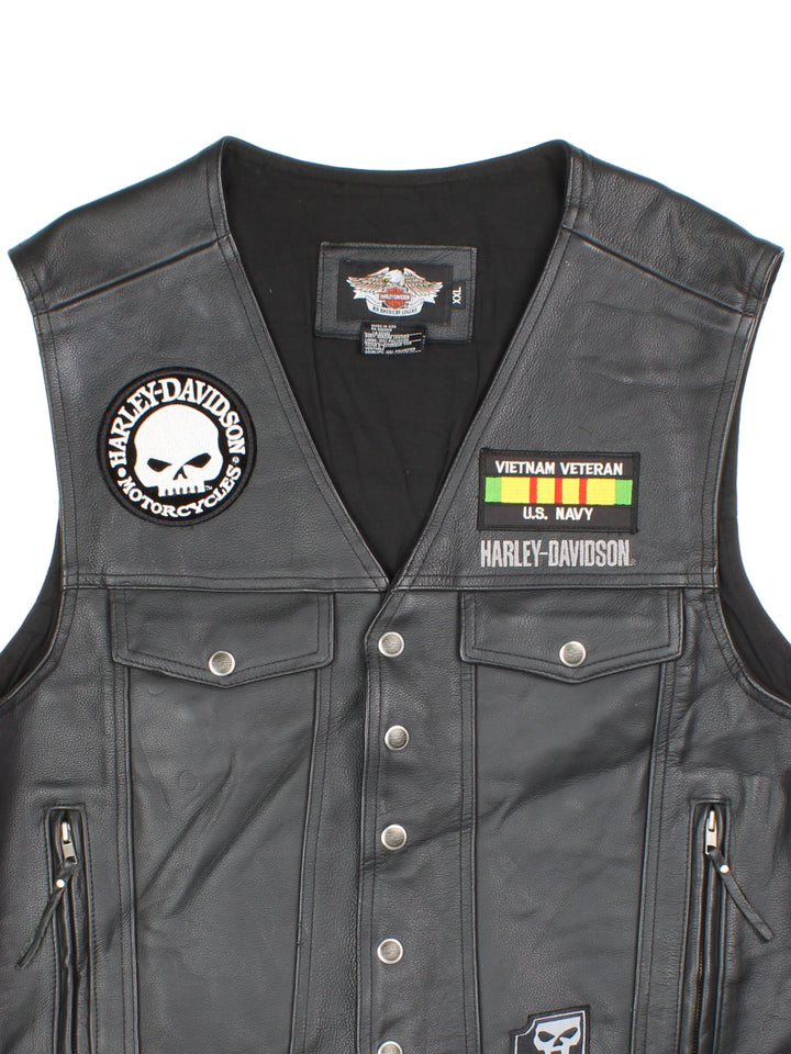 Vintage Harley-Davidson Leather Biker Vest in a black colourway. Buttons up and has multiple pockets, and has embroidered logos and badges on the front.