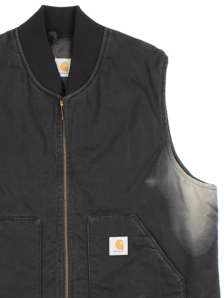 Vintage Carhartt Gilet in a black colourway. Zips up and has side pockets, insulated with a quilted lining, and has the logo embroidered on the front.