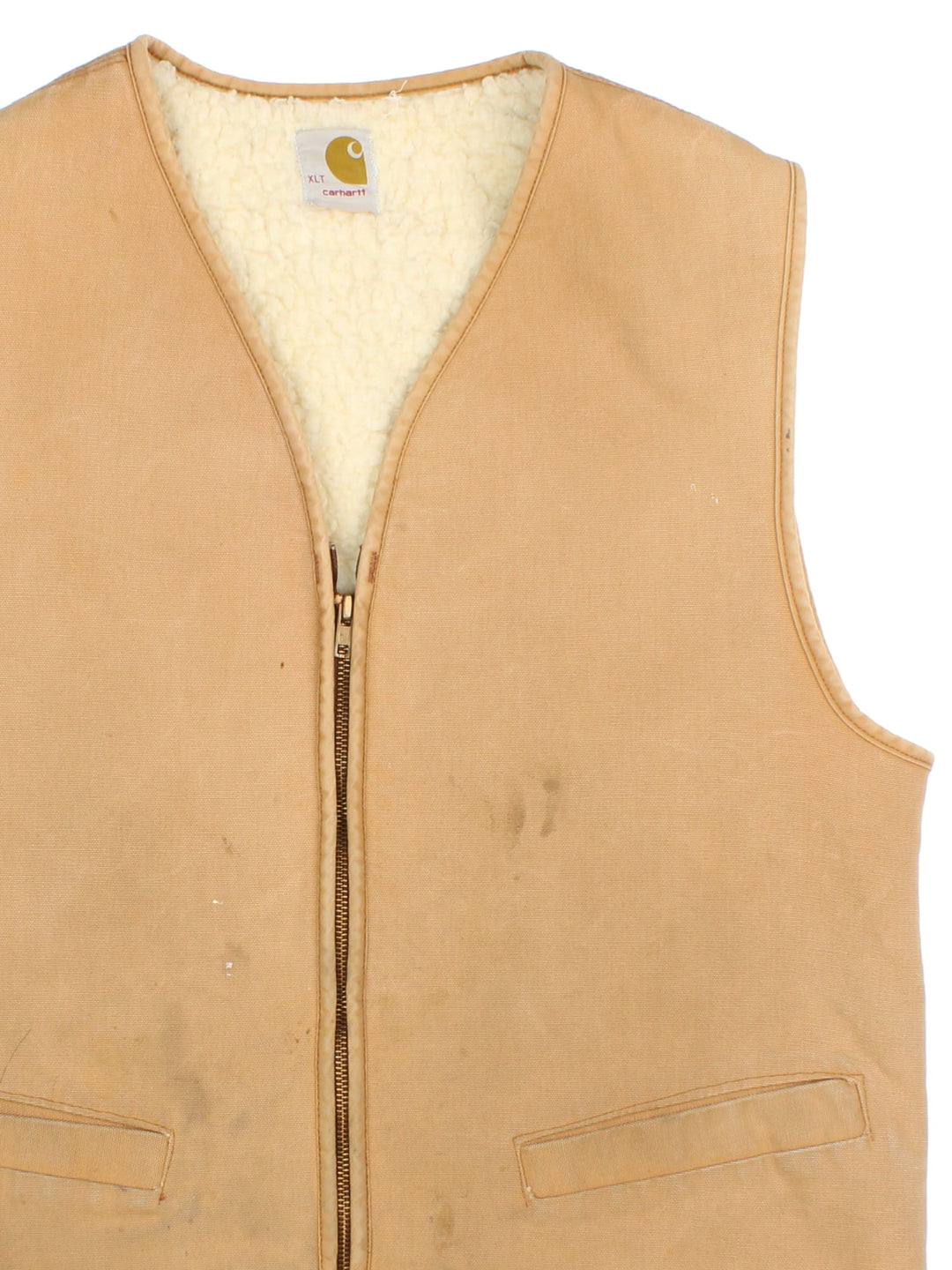 Vintage Carhartt Gilet in a tan colourway. Zips up and has side pockets and is insulated with a sherpa lining.