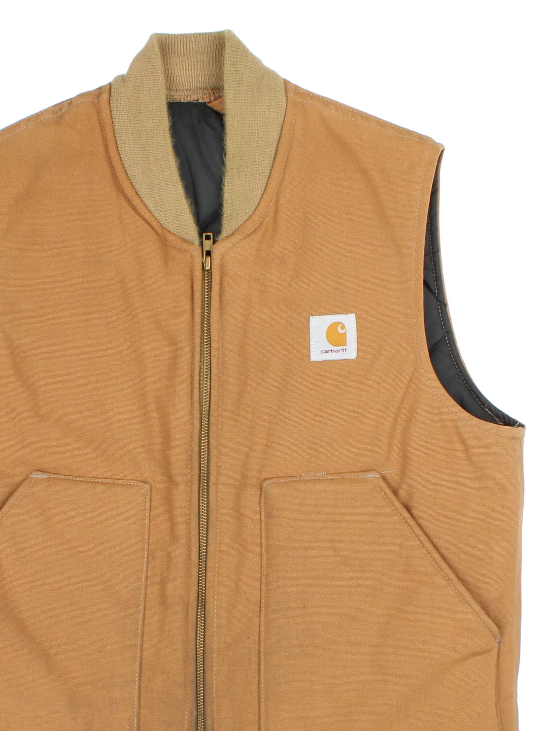 Vintage 80's Carhartt Gilet in a tan colourway. Zips up and has side pockets, insulated with a quilted lining, and has the logo embroidered on the front.