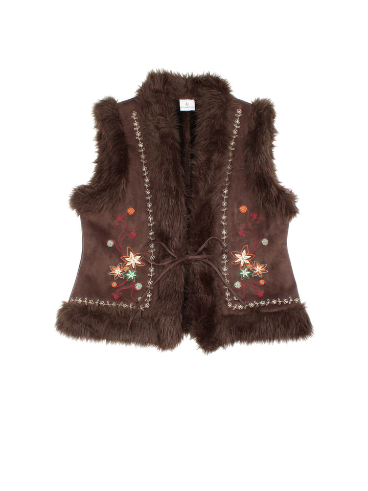 Y2K Floral Faux Fur Vest in a brown colourway. Ribbon closure, has side pockets, faux fur lining, and has floral patterns embroidered on the front.