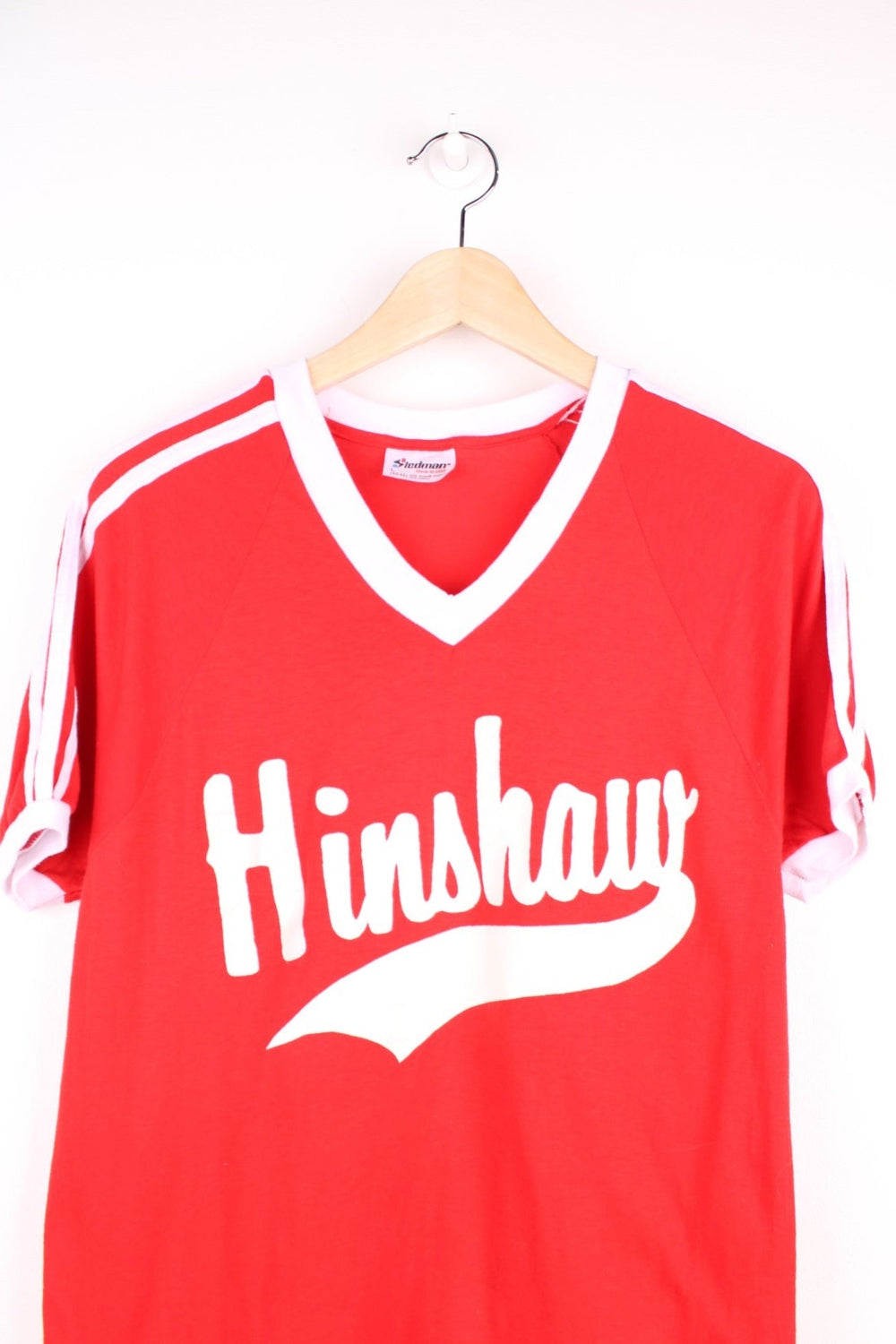 Vintage 70's Hinshaw Baseball T-Shirt in a red and white colourway, has a v neck collar, stripes going down the sleeves, and 'Hinshaw' spell out printed on the front as well as the number 3 on the back. 