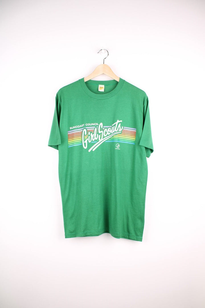 Vintage Suncoast Council Girl Scouts T-Shirt in a green colourway with the spell out logo printed across the front with rainbow coloured stripes going through it. 