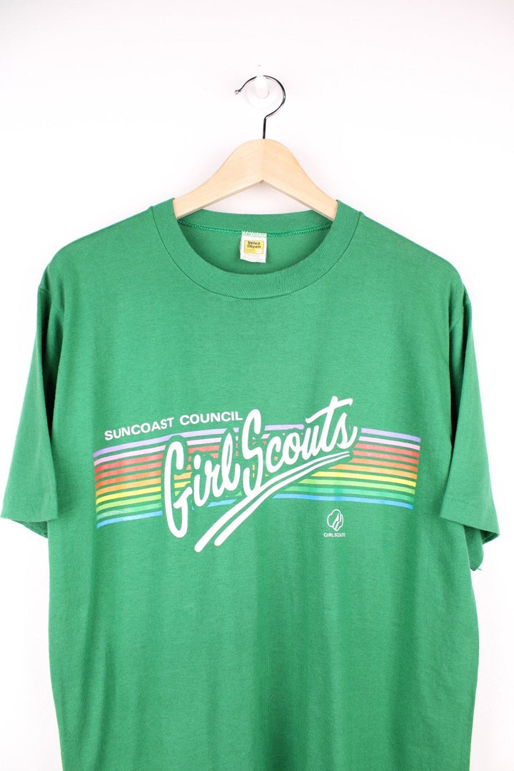 Vintage Suncoast Council Girl Scouts T-Shirt in a green colourway with the spell out logo printed across the front with rainbow coloured stripes going through it. 