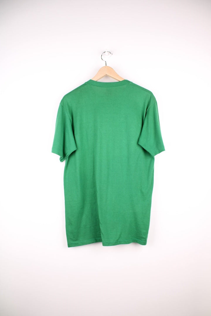 Vintage Suncoast Council Girl Scouts T-Shirt in a green colourway with the spell out logo printed across the front with rainbow coloured stripes going through it. 