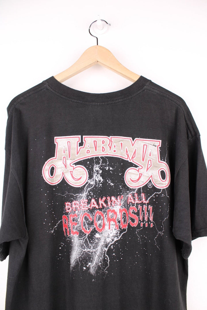 Vintage 1998 Alabama Band Tour T-Shirt in a black colourway with the bands spell out logo and picture printed on the front and has 'breakin all records' graphic on the back.