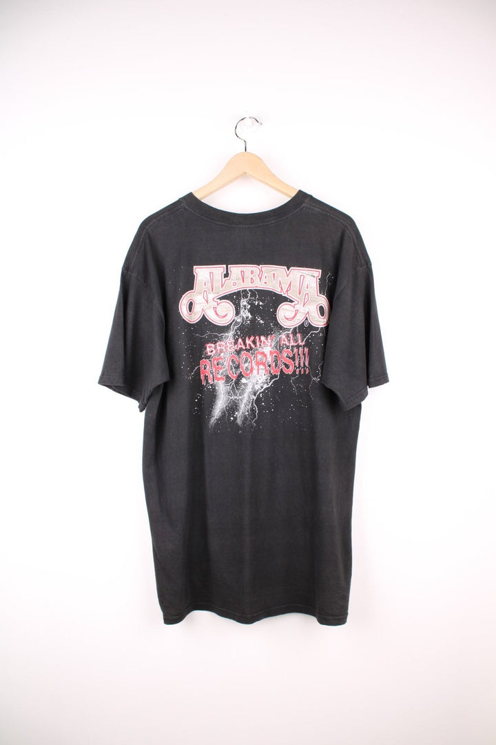 Vintage 1998 Alabama Band Tour T-Shirt in a black colourway with the bands spell out logo and picture printed on the front and has 'breakin all records' graphic on the back.