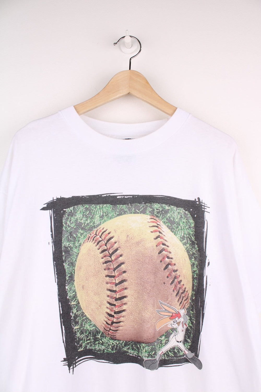 Vintage Warner Bros Bugs Bunny Baseball T-Shirt in a white colourway with Bugs Bunny hitting a big baseball printed on the front. 