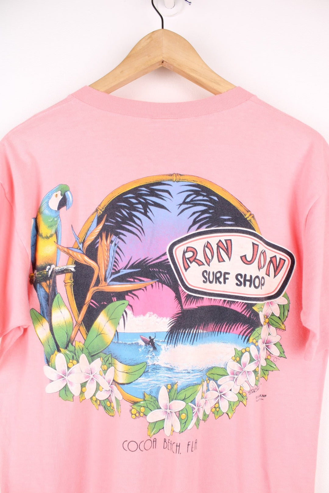 Vintage 80s Ron Jon Surf Shop, Cocoa Beach single stitch T-Shirt with printed logo and pocket on the chest pocket, and graphic print on the back.