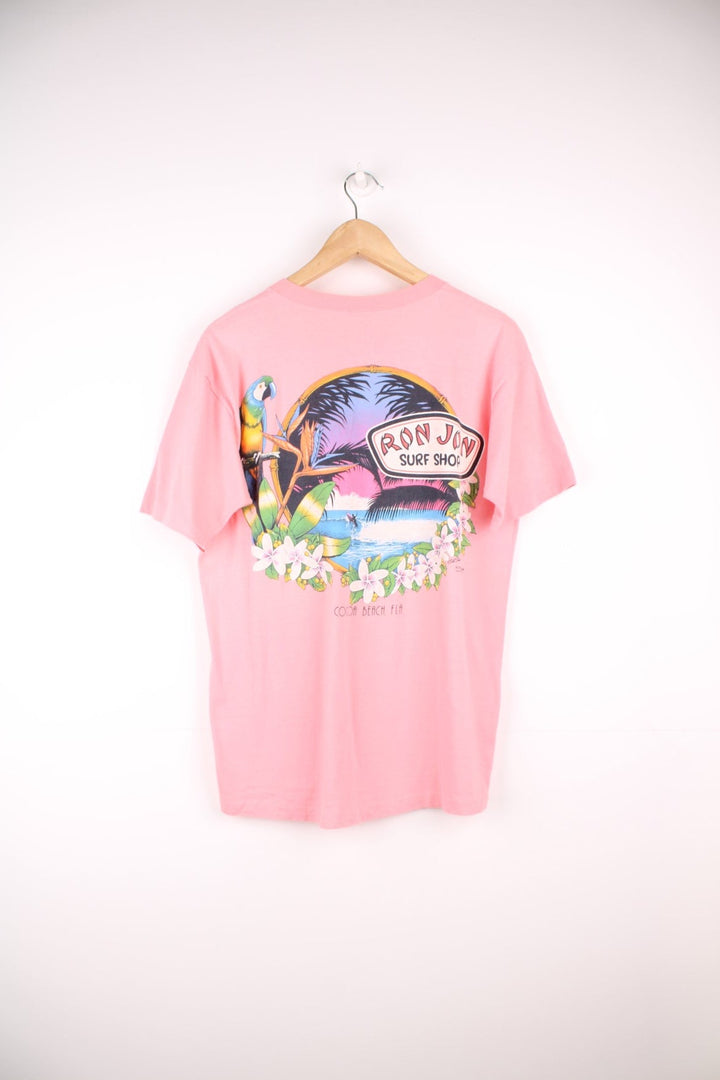 Vintage 80s Ron Jon Surf Shop, Cocoa Beach single stitch T-Shirt with printed logo and pocket on the chest pocket, and graphic print on the back.