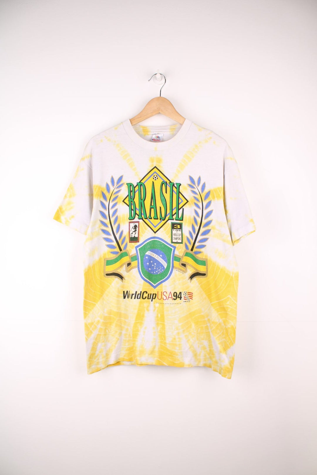 World Cup USA 1994 team Brasil tee in yellow tie-dye with flag crest graphic on the front and Brasil spellout on the back. 