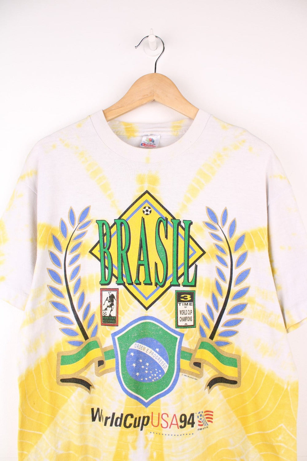 World Cup USA 1994 team Brasil tee in yellow tie-dye with flag crest graphic on the front and Brasil spellout on the back. 