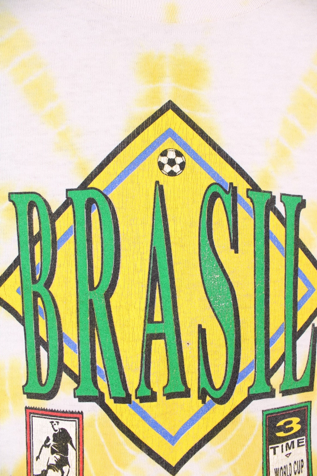 World Cup USA 1994 team Brasil tee in yellow tie-dye with flag crest graphic on the front and Brasil spellout on the back. 