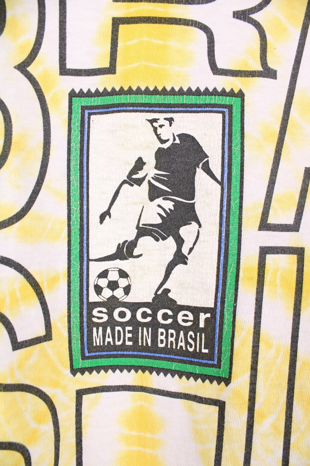 World Cup USA 1994 team Brasil tee in yellow tie-dye with flag crest graphic on the front and Brasil spellout on the back. 