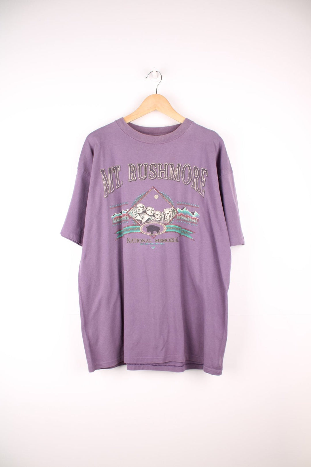 Purple Mt. Rushmore graphic tee with geometric landscape design. 