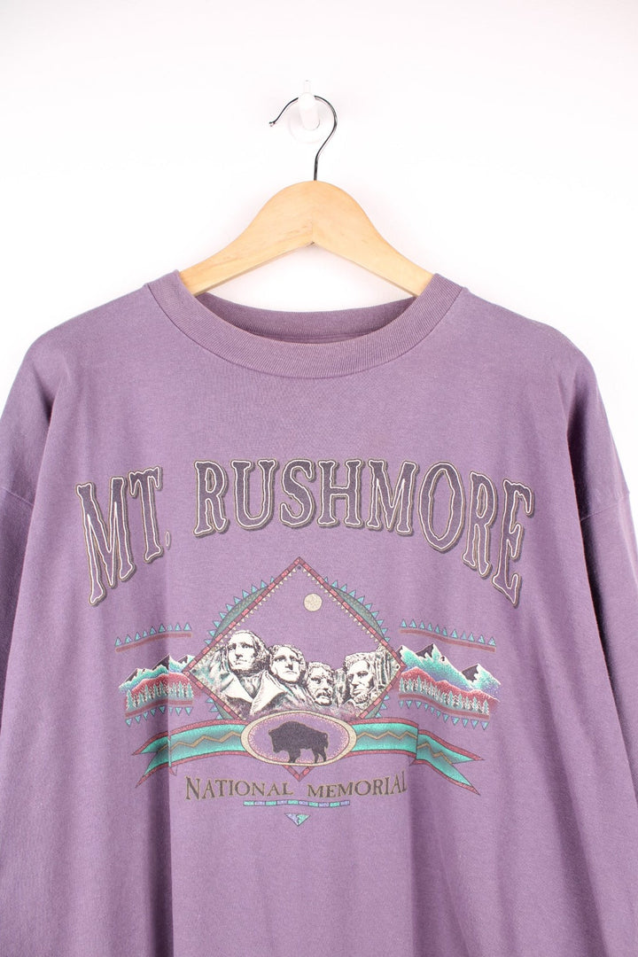 Purple Mt. Rushmore graphic tee with geometric landscape design. 