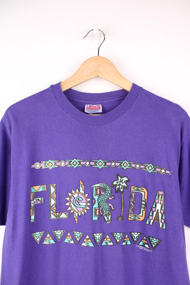 Purple Florida spellout tee with geometric designs. 