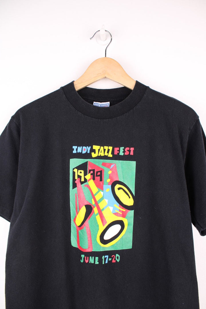 Black tee with text reading 'Indy Jazz Fest 1999 June 17-20 and a colourful geometric instrument graphic. 