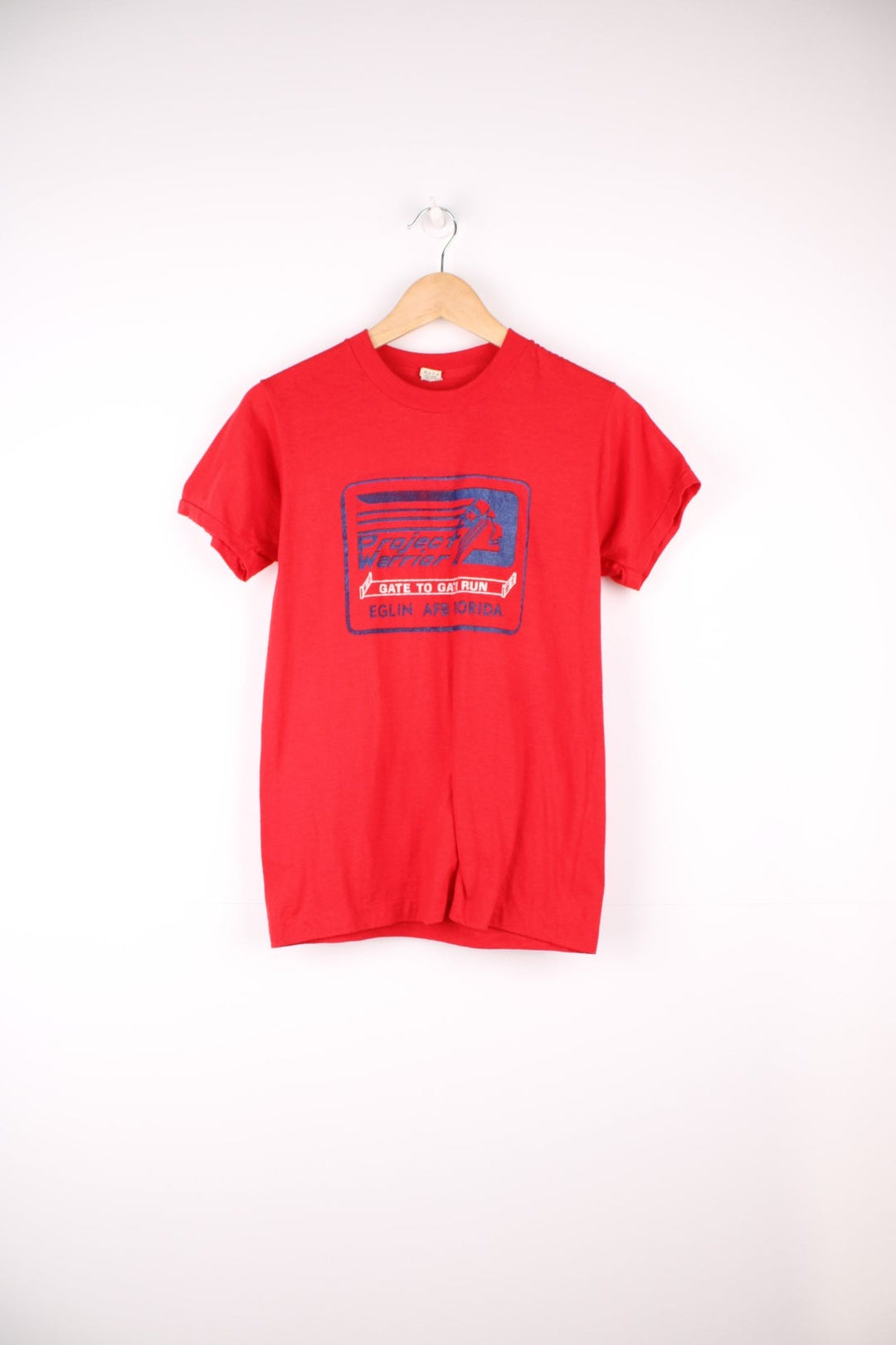 Vintage 1980's all red single stitch t-shirt features "Project Warrior" graphic on the front