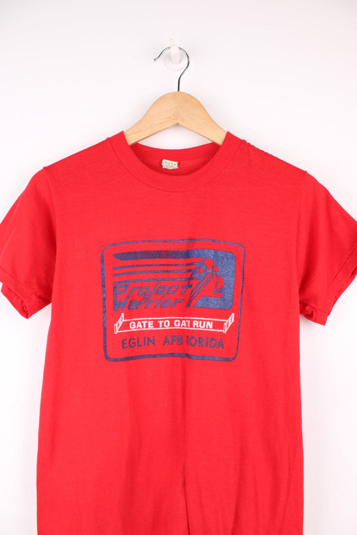 Vintage 1980's all red single stitch t-shirt features "Project Warrior" graphic on the front