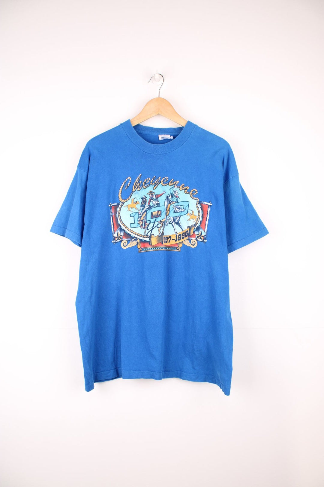 Vintage 1996 Cheyenne Cowboy, 100 Year Anniversary graphic t-shirt in a bright blue colourway. Features single stitching on the sleeves and printed motif on the front and back