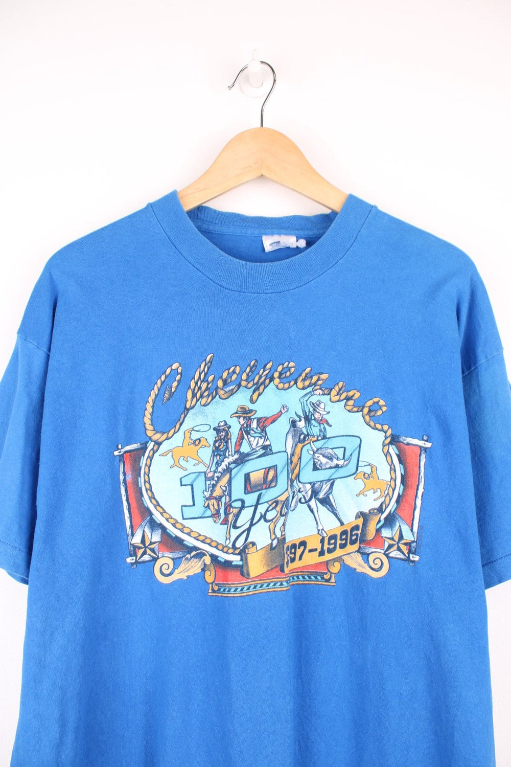 Vintage 1996 Cheyenne Cowboy, 100 Year Anniversary graphic t-shirt in a bright blue colourway. Features single stitching on the sleeves and printed motif on the front and back