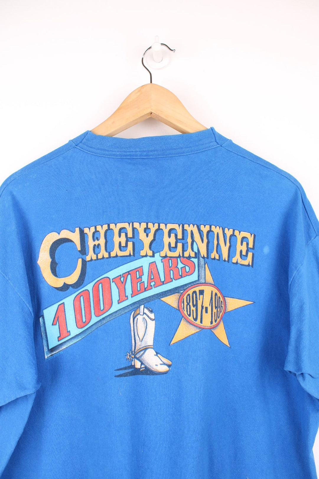 Vintage 1996 Cheyenne Cowboy, 100 Year Anniversary graphic t-shirt in a bright blue colourway. Features single stitching on the sleeves and printed motif on the front and back