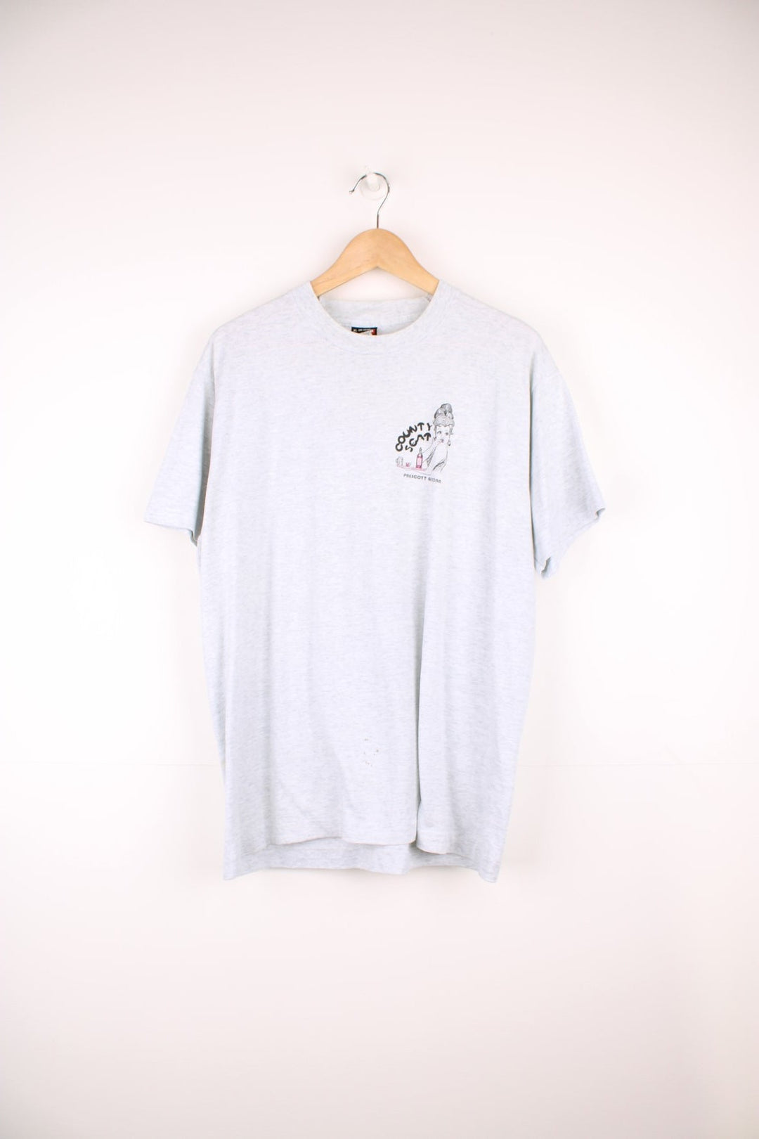 Vintage 90's single stitch "County Seat Bar & Grill" graphic t-shirt in grey colourway. Features 50's style waitress graphic on the front and back  