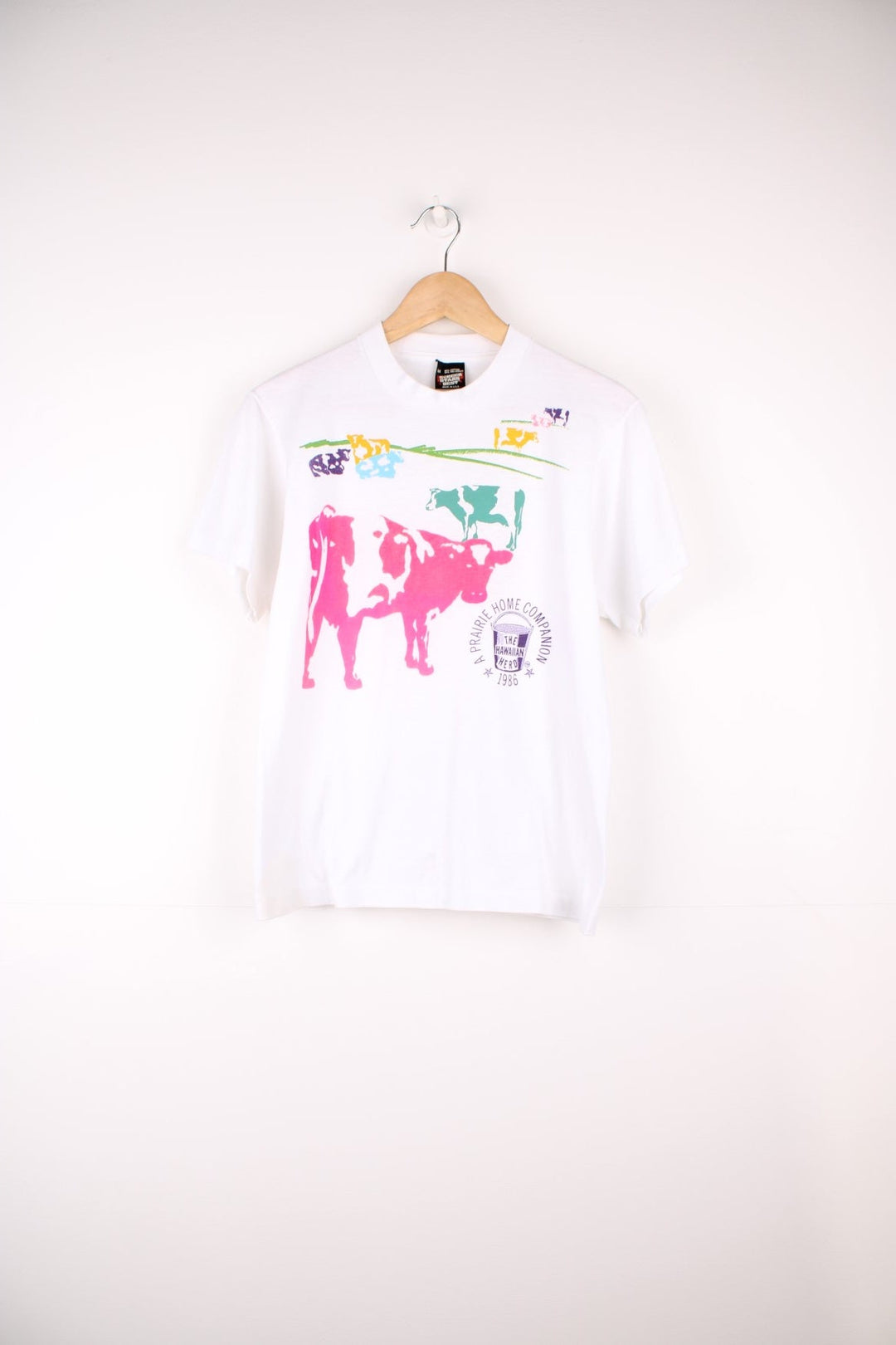 Vintage Screen Stars Best 90's single stitch "The Hawaiian Herd" graphic t-shirt. Features all over cow print on the front.