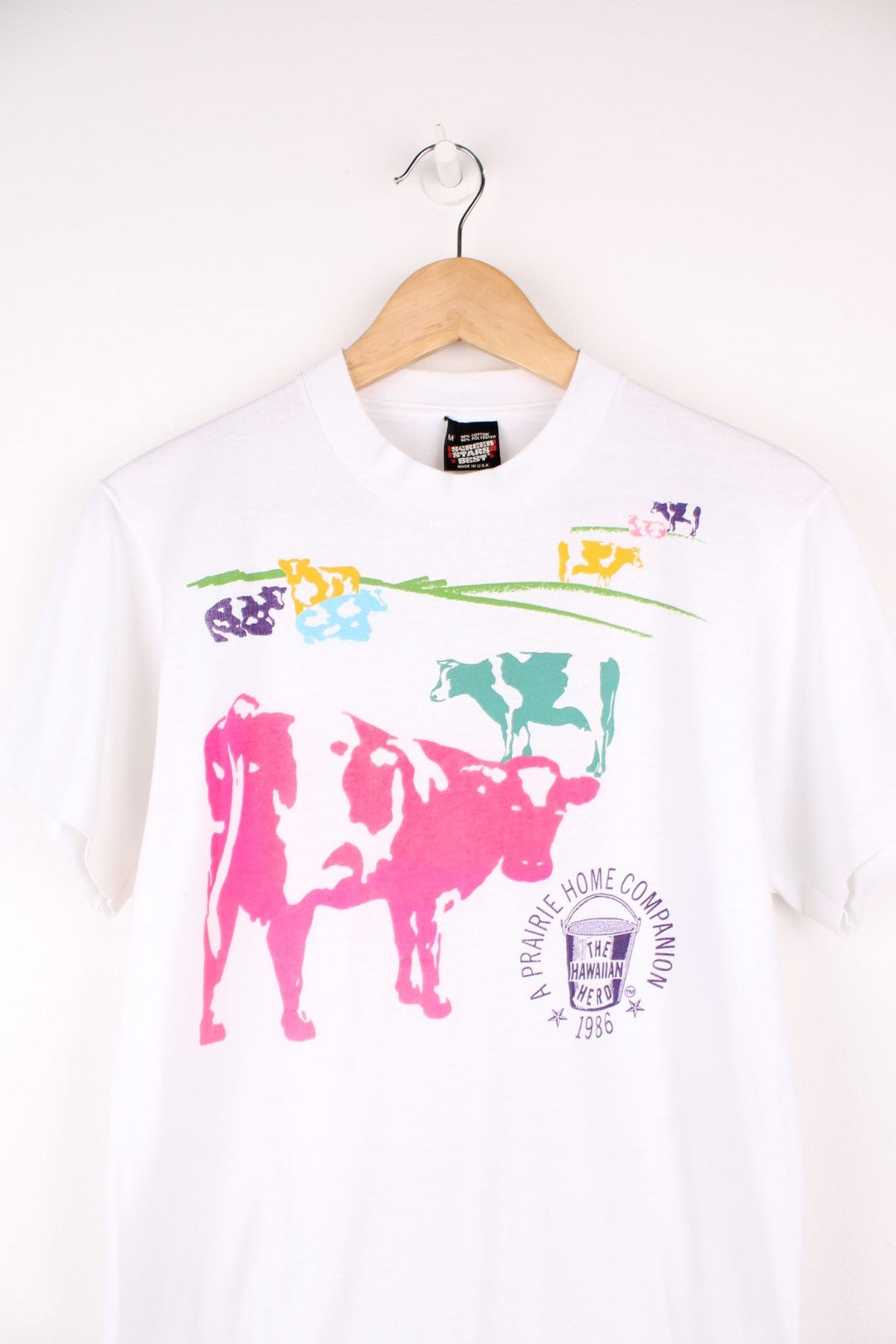 Vintage Screen Stars Best 90's single stitch "The Hawaiian Herd" graphic t-shirt. Features all over cow print on the front.