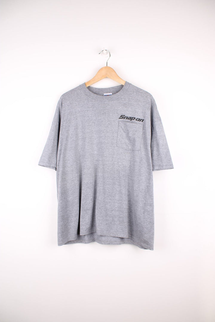 Snap-On T-Shirt in grey with pocket and printed logo on the chest, and large graphic sun print on the back.