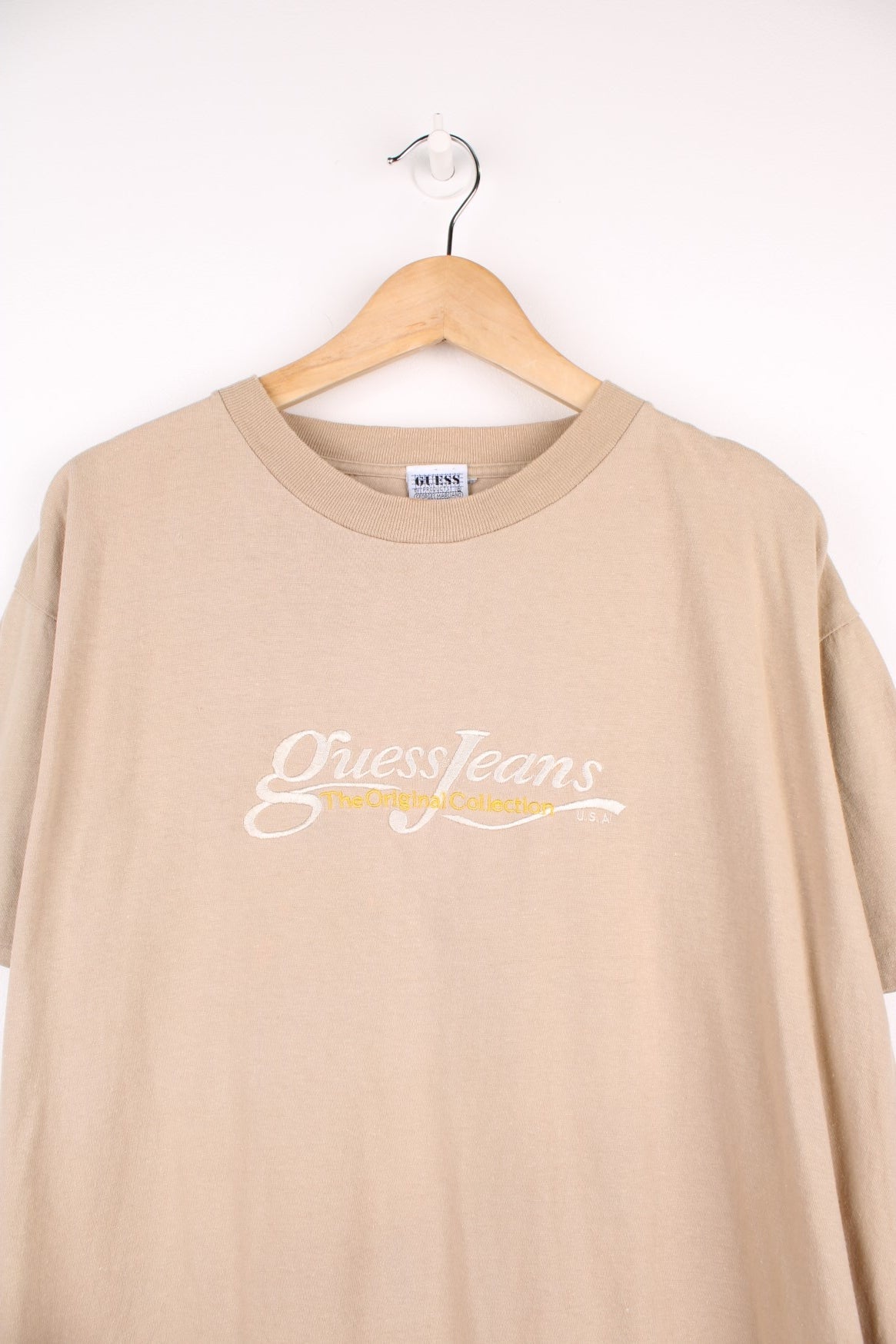 Vintage 90s Guess by Georges Marciano single stitch T-Shirt in a light brown colourway. Features embroidered Guess Jeans logo across the chest.