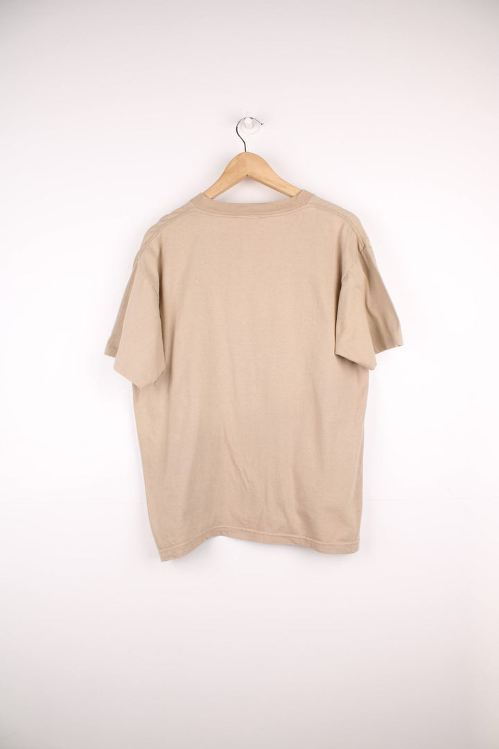 Vintage 90s Guess by Georges Marciano single stitch T-Shirt in a light brown colourway. Features embroidered Guess Jeans logo across the chest.