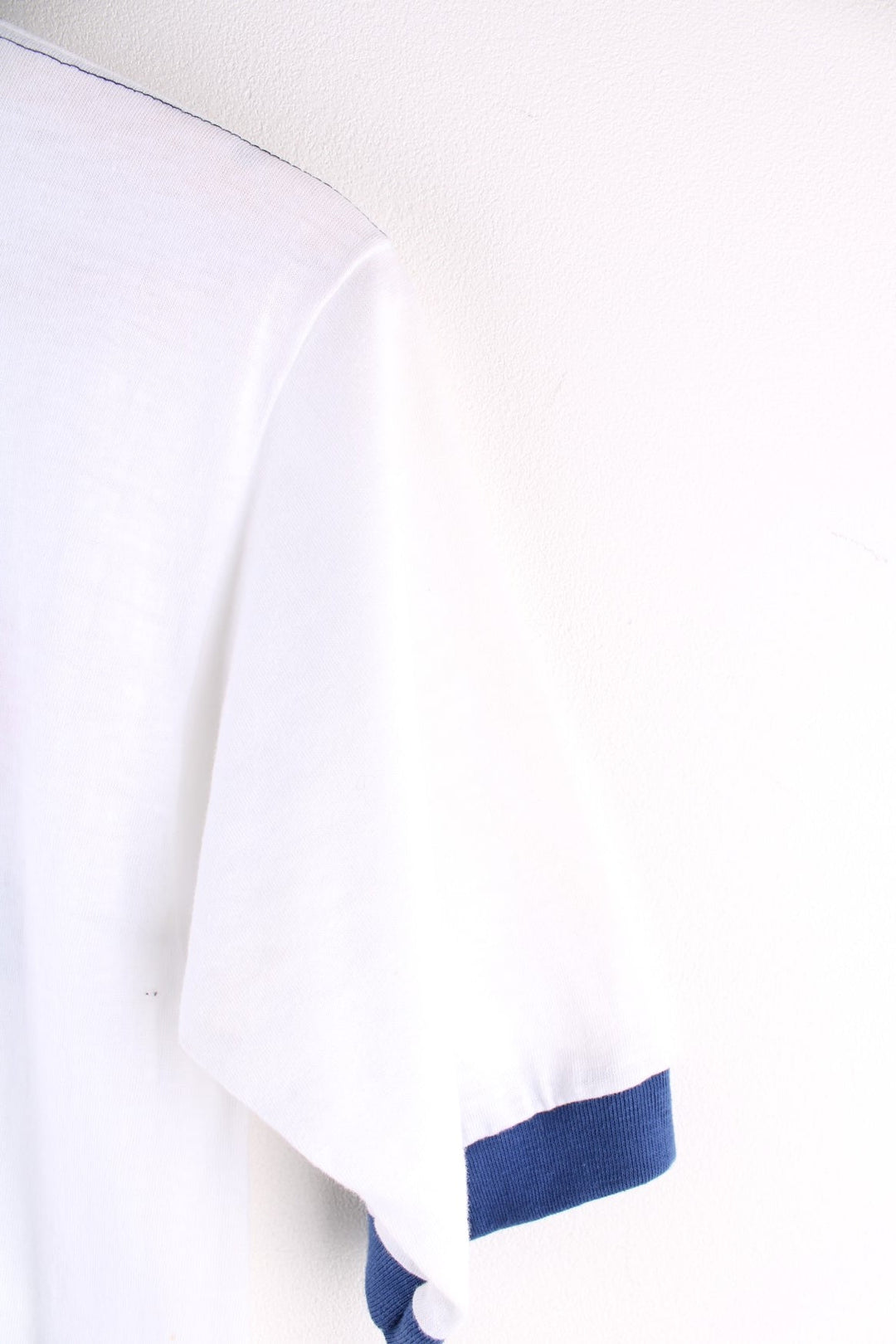  Vintage 1980s Hershey's Chocolate Ringer T Shirt in a white and navy blue colourway. The shirt has a graphic printed on the front, has double stitching on the shoulder seams and has a single stitch hem. 