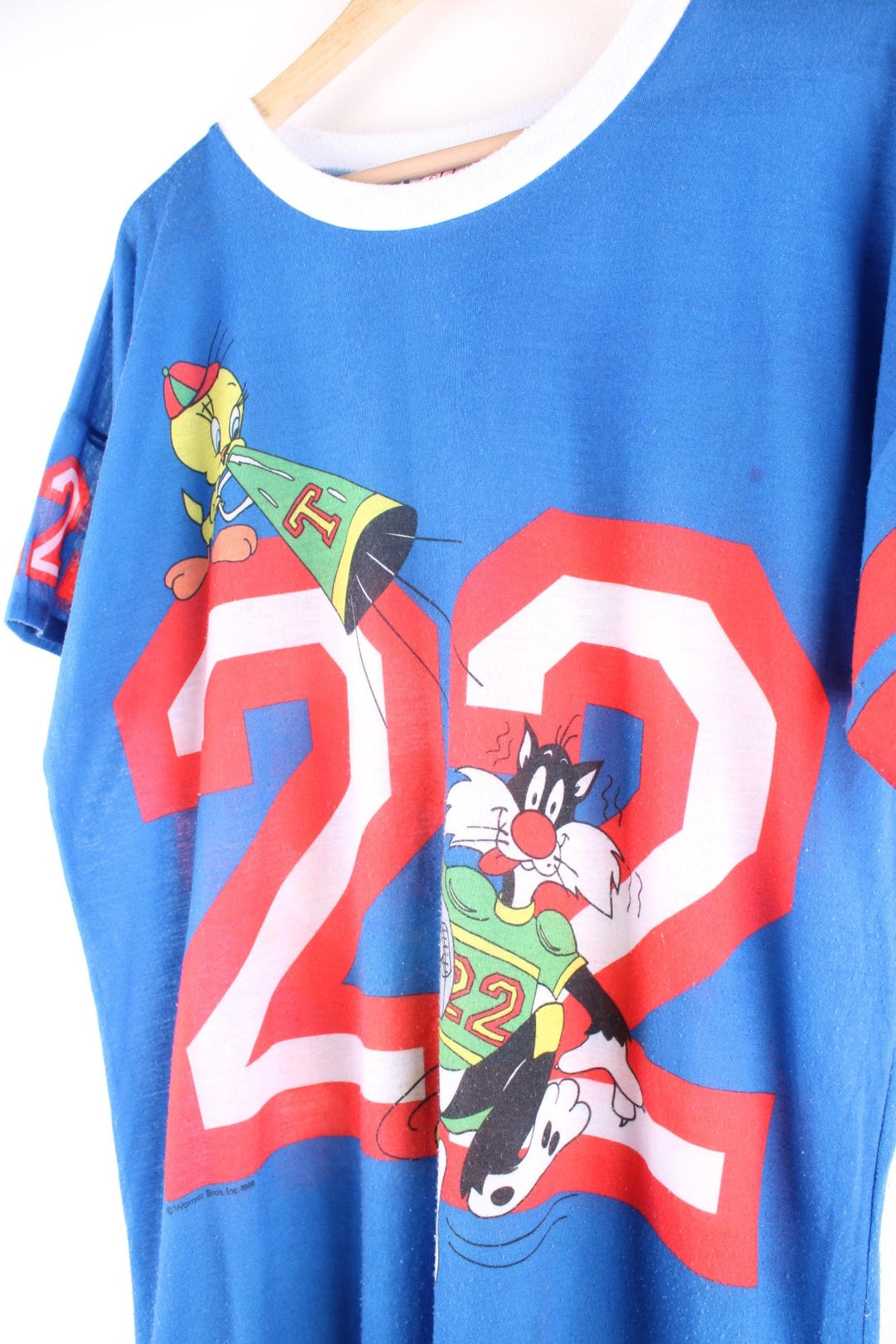 Vintage 1980s Jodie Arden Pyjama shirt in a blue colourway. There is a large graphic printed on the front, with Sylvester and Tweety and the sleeves are sports jersey style with a single stitch hem. 