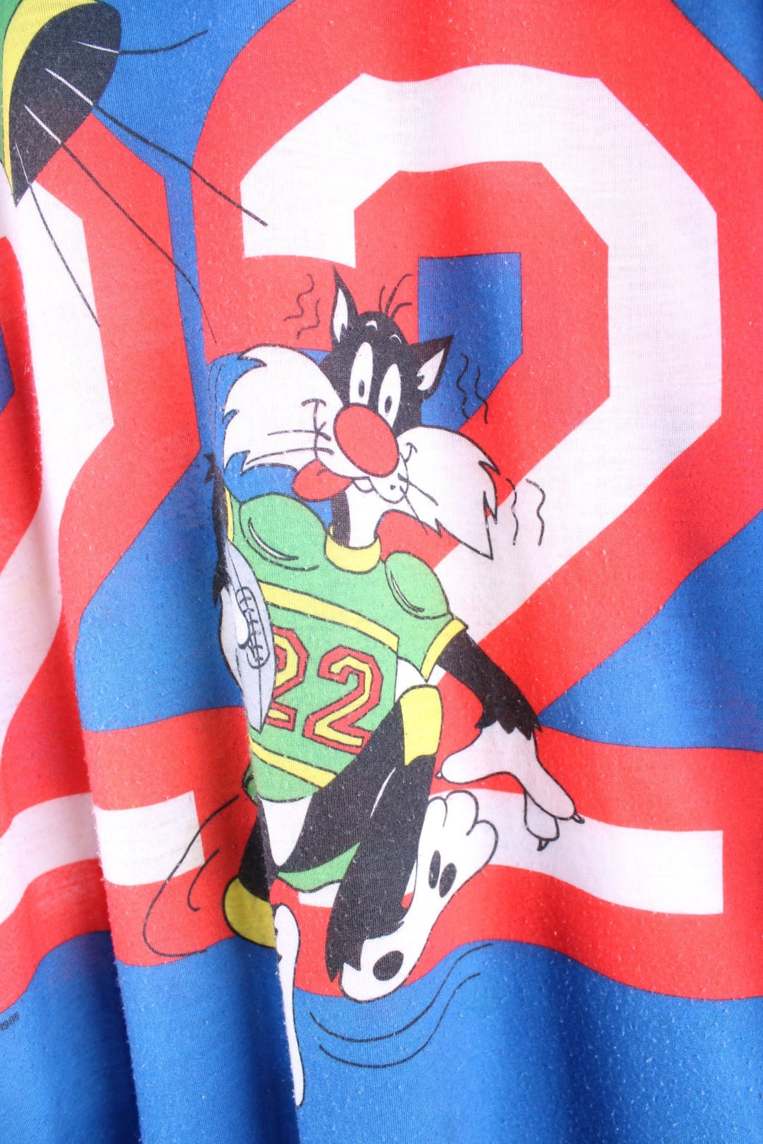 Vintage 1980s Jodie Arden Pyjama shirt in a blue colourway. There is a large graphic printed on the front, with Sylvester and Tweety and the sleeves are sports jersey style with a single stitch hem. 