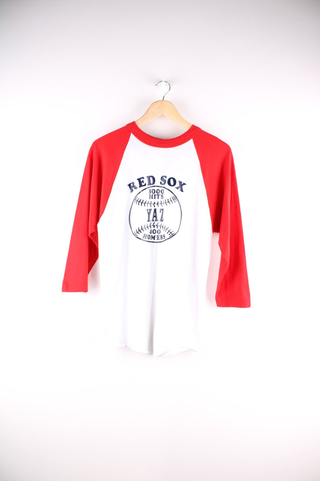 Vintage 1979 Boston Red Sox raglan T-Shirt in a white and red sleeved colourway. The shirt has a navy graphic printed on the front, single stitch sleeve cuffs and a rolled hem. The shirt is to honour the player Carl Yastrzemski after he made his 3000th hit and 400th home run for the team on September 12th 1979.  Made in the USA.  