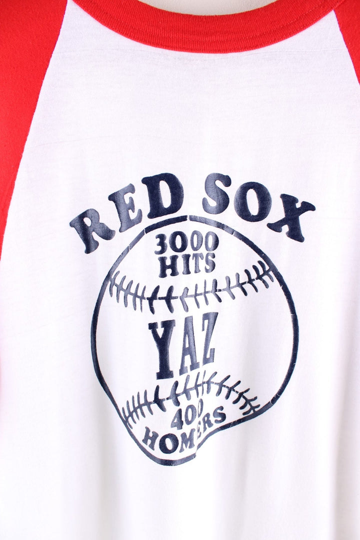 Vintage 1979 Boston Red Sox raglan T-Shirt in a white and red sleeved colourway. The shirt has a navy graphic printed on the front, single stitch sleeve cuffs and a rolled hem. The shirt is to honour the player Carl Yastrzemski after he made his 3000th hit and 400th home run for the team on September 12th 1979.  Made in the USA.  