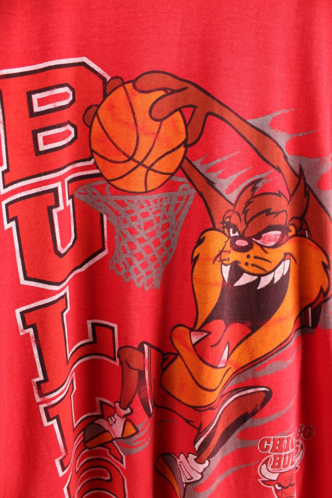 Vintage 1990s Chicago Bulls / Taz Looney Tunes T-Shirt in a red colourway. The shirt has a large graphic printed on the front. Made by Screen Stars.   